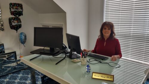 Woman sitting at desk with computer