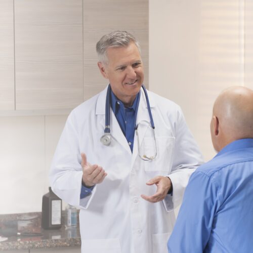 Doctor speaking with patient in doctors office