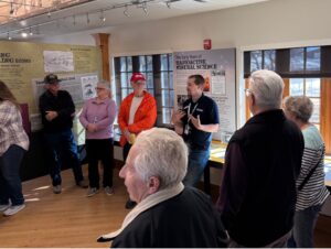 museum tour guide speaking to group of people