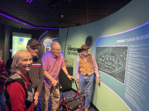 Four people looking at exhibit at museum