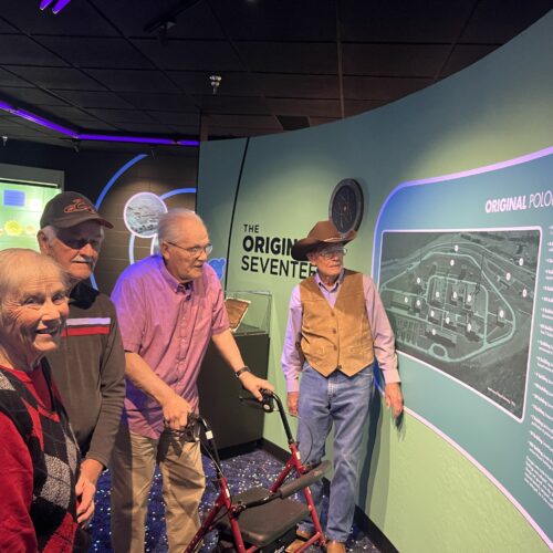 Four people looking at exhibit at museum