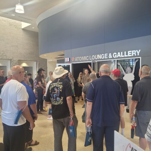 patrons standing listening to museum guide