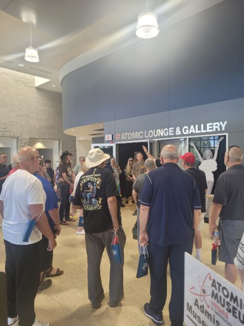 patrons standing listening to museum guide