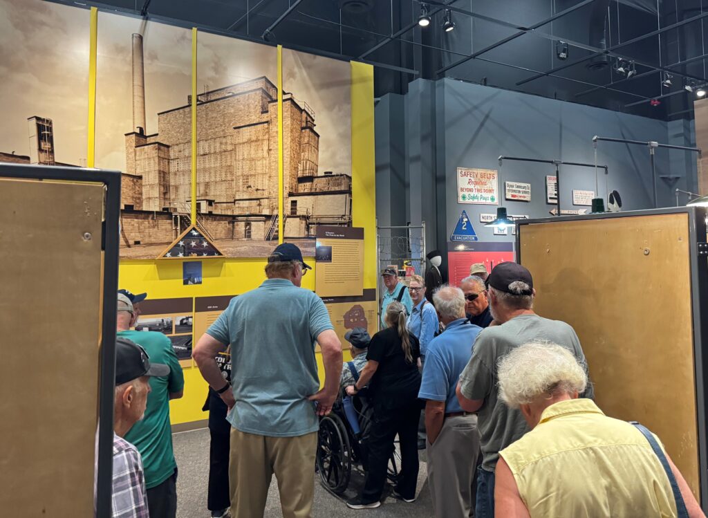 Museum patrons wandering around exhibit