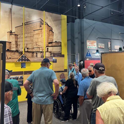 Museum patrons wandering around exhibit