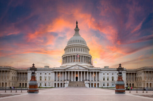 U.S. capitol building with a sunset in the background