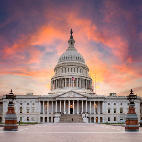 U.S. capitol building with a sunset in the background
