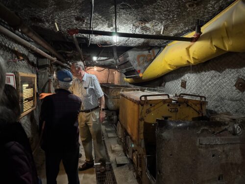 Man reviewing exhibit information at the New Mexico science museum.